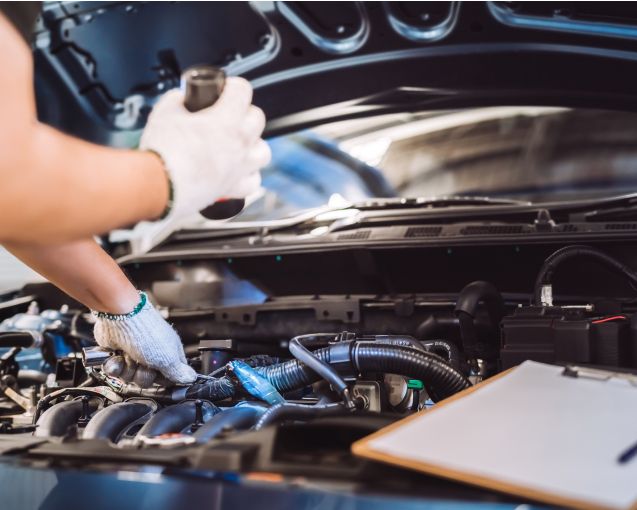 Mann der an einen Automotor arbeitet